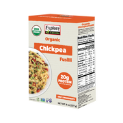 A box of Explore Cuisine Organic Chickpea Fusilli features a colorful pasta dish on the front, highlighting its 20 grams of protein per serving and listing nutrition facts on the side.