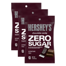 Three packages of Hershey's Zero Sugar chocolate candy are displayed, featuring bold white text on a maroon background, highlighting that they are aspartame-free and contain 130 calories per serving.