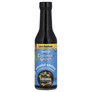 A black bottle of Nutiva Coconut Secret coconut aminos, labeled as a soy-free sauce alternative, features a blue background with tropical designs and highlights "Less Sodium" and "Original Sweet & Savory."