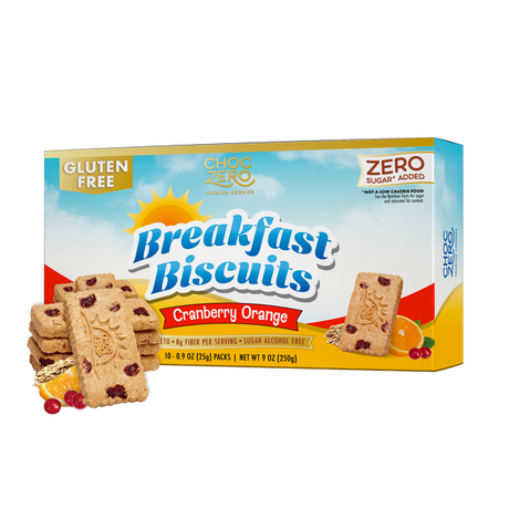 A box of ChocZero gluten-free breakfast biscuits in cranberry orange flavor, featuring several biscuits stacked beside the box, with orange slices and cranberries in the foreground.