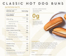 Nutrition facts for classic hot dog buns are displayed, featuring a serving size of one bun, with details on calories, fat, carbohydrates, and ingredients, alongside two buns on a white plate.