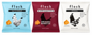 Three colorful snack bags of Flock Chicken Skin Crisps are displayed, featuring flavors: Salt & Vinegar, Barbecue Seasoned, and Original, with nutritional information highlighted on each bag.