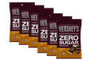 Six packages of Hershey's Zero Sugar caramel-filled chocolate candy are displayed, each labeled with the product name and details, emphasizing that they are aspartame-free and weigh 3 ounces.
