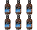 Six bottles of G. Hughes Zero Sugar Hickory BBQ Sauce are displayed in a grid, featuring a dark label with blue accents and images of grilled meat on the front, emphasizing its sugar-free and gluten-free qualities.