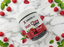 A container of Bariatric Pal Iron Chew in Sour Raspberry flavor is surrounded by fresh raspberries and mint leaves on a marble surface, emphasizing its dietary supplement benefits.