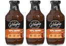 Three bottles of G Hughes Zero Sugar Maple Brown Flavored BBQ Sauce are displayed, featuring a dark brown liquid and labels highlighting "gluten & dairy free" and nutritional information.