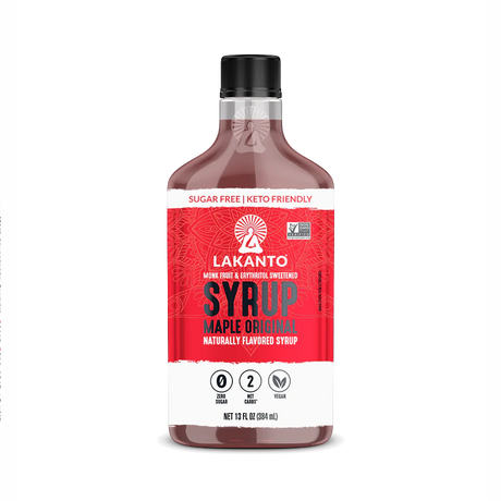 A bottle of Lakanto Maple Original Syrup, labeled as sugar-free, keto-friendly, and vegan, features a vibrant red design with nutritional information and a logo on a white background.