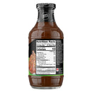 A clear glass bottle of zero-sugar barbecue sauce displays a nutrition facts label on the side, detailing serving size, calories, and ingredients like tomatoes and spices.