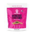 A bright pink package of Lakanto Monkfruit Sweetener with Erythritol, labeled as "Brown" and featuring icons for zero net carbs and keto-friendly, is displayed against a plain background.