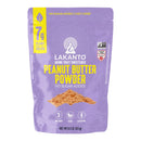 A purple bag of Lakanto Monk Fruit Sweetened Peanut Butter Powder, featuring bold yellow text, highlights its no sugar added, vegan, and gluten-free attributes, with 7 grams of plant-based protein per serving.