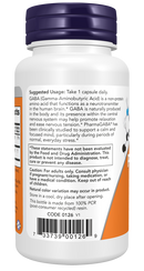 A white bottle with a purple cap contains GABA dietary supplement, displaying usage instructions, cautionary notes, and a barcode on the label, emphasizing its calming effects for everyday stress.