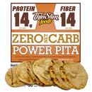 A package of Thin Slim Foods Power Pita displays nutritional information highlighting 14 grams of protein and fiber per pita, with several pita breads arranged in front.