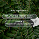 Text overlays on a background of green leaves highlight key ingredients: iron (murraya koenigii extract) for red blood cell production and vitamin C for cell protection and immune support.