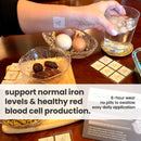 A hand with a patch on the wrist holds a glass of water, while a bowl of dates and eggs sits on a table, alongside informational cards about a product supporting iron levels and blood cell production.
