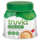 A container of Truvia Stevia Leaf sweetener features a green lid and label, highlighting its plant-based, calorie-free formula, alongside a cup of coffee with frothy milk.