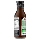 A brown sauce bottle with a black cap labeled "Zero Sugar" displays nutrition facts and a description of the creator, Guy Hughes, on the back, set against a plain background.