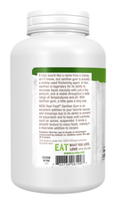 A white bottle of NOW Real Food® Xanthan Gum displays a detailed label highlighting its uses as a thickening agent and cooking ingredient, with cautionary notes about consumption by young children.