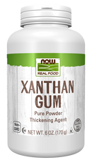 A white container of xanthan gum powder labeled "NOW Real Food," highlighting its use as a thickening agent, with details about being gluten-free and non-GMO.